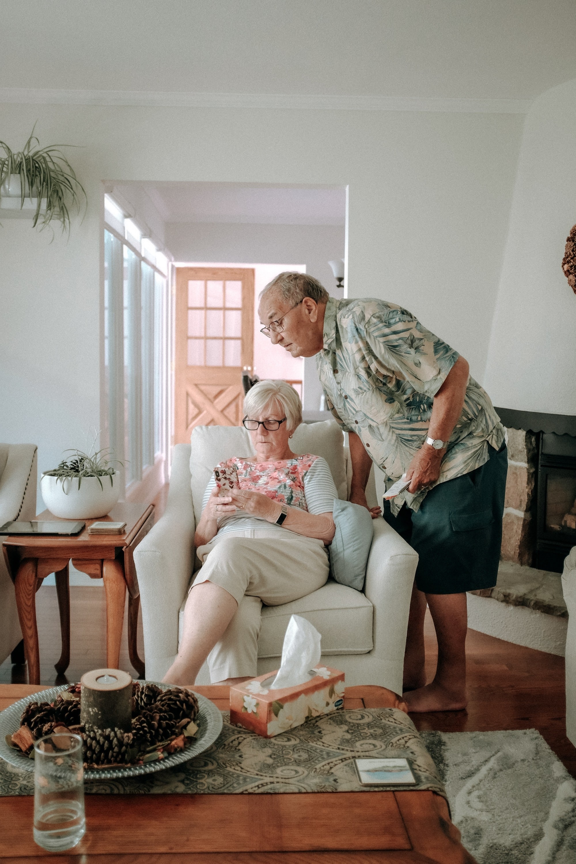 Chris Frith, Physiotherapist wearing red checked shirt, performs massage on the leg of a client who is wearing a blue tee shirt.