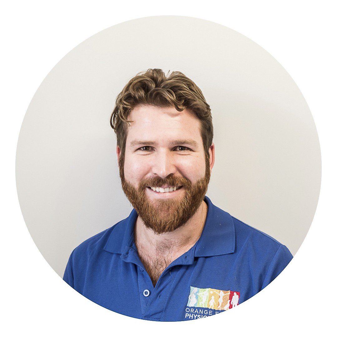 Staff photo of Chris Frith, wearing an Orange Family Physiotherapy blue polo shirt in front of a plain grey background.